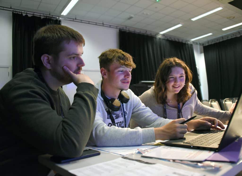 3 young people learning together.