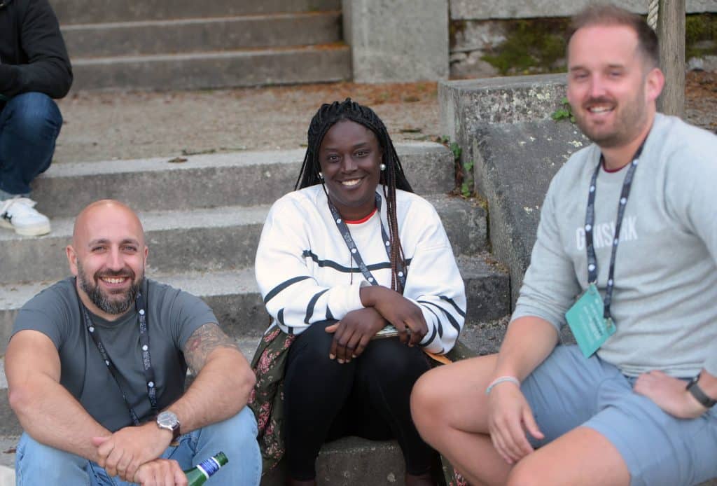 A trio sat on the steps at Agile on The Beach.