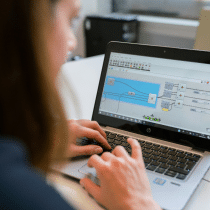 A woman taking part in tech training on a laptop.