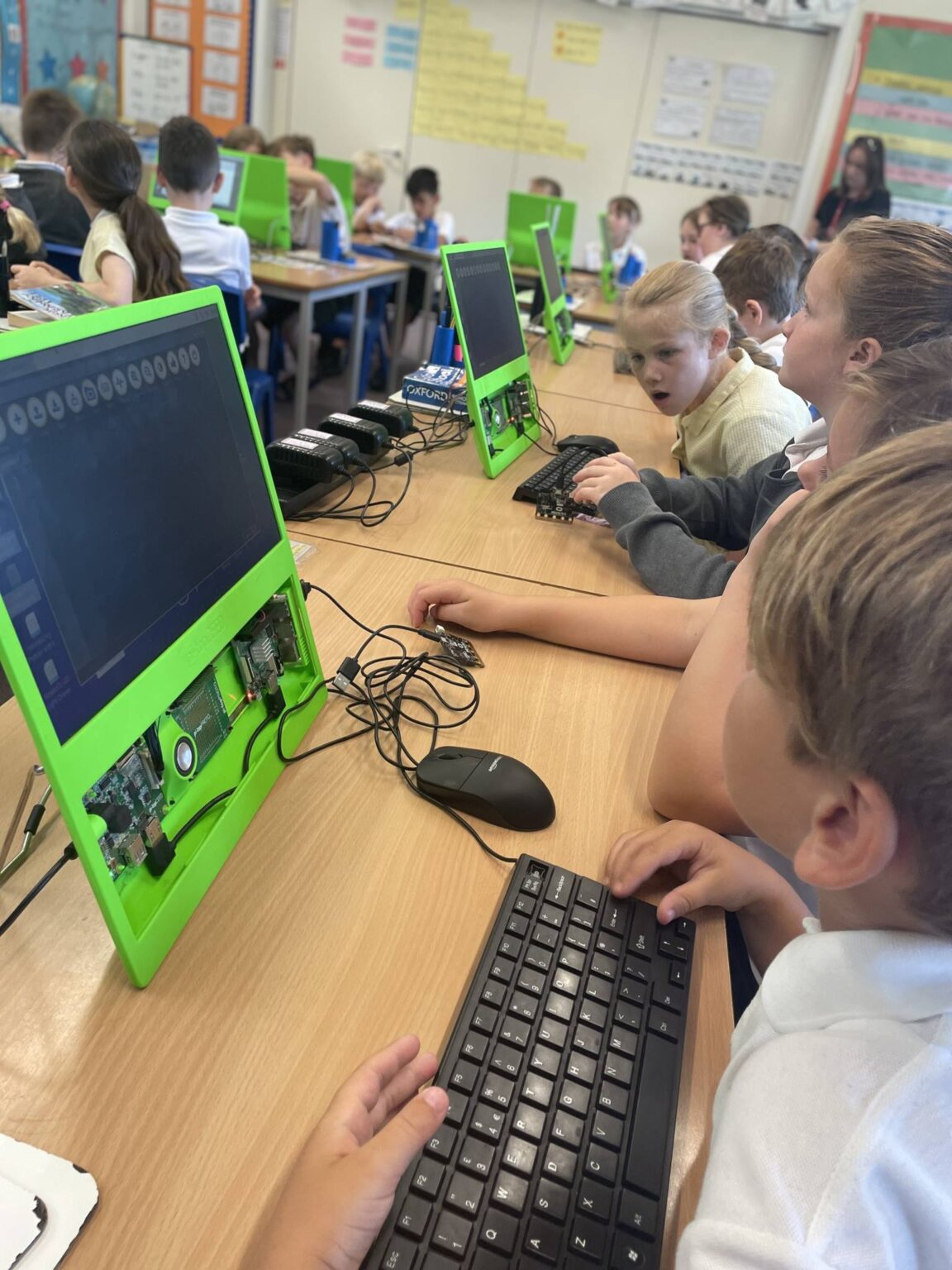 A class of students having a workshop with Raspberry Pi computers