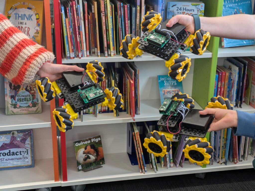 Kids from a Tech Jam event in Cornwall holding rover robots